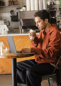 Guy working and having coffee